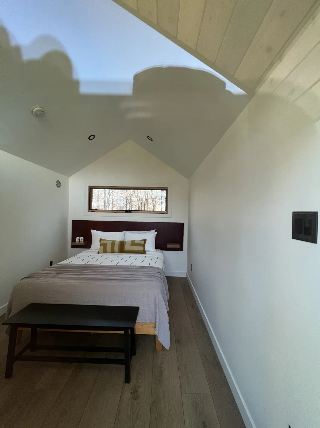Clean cabin interior with vaulted ceiling and bed at Rancho Moonrise
