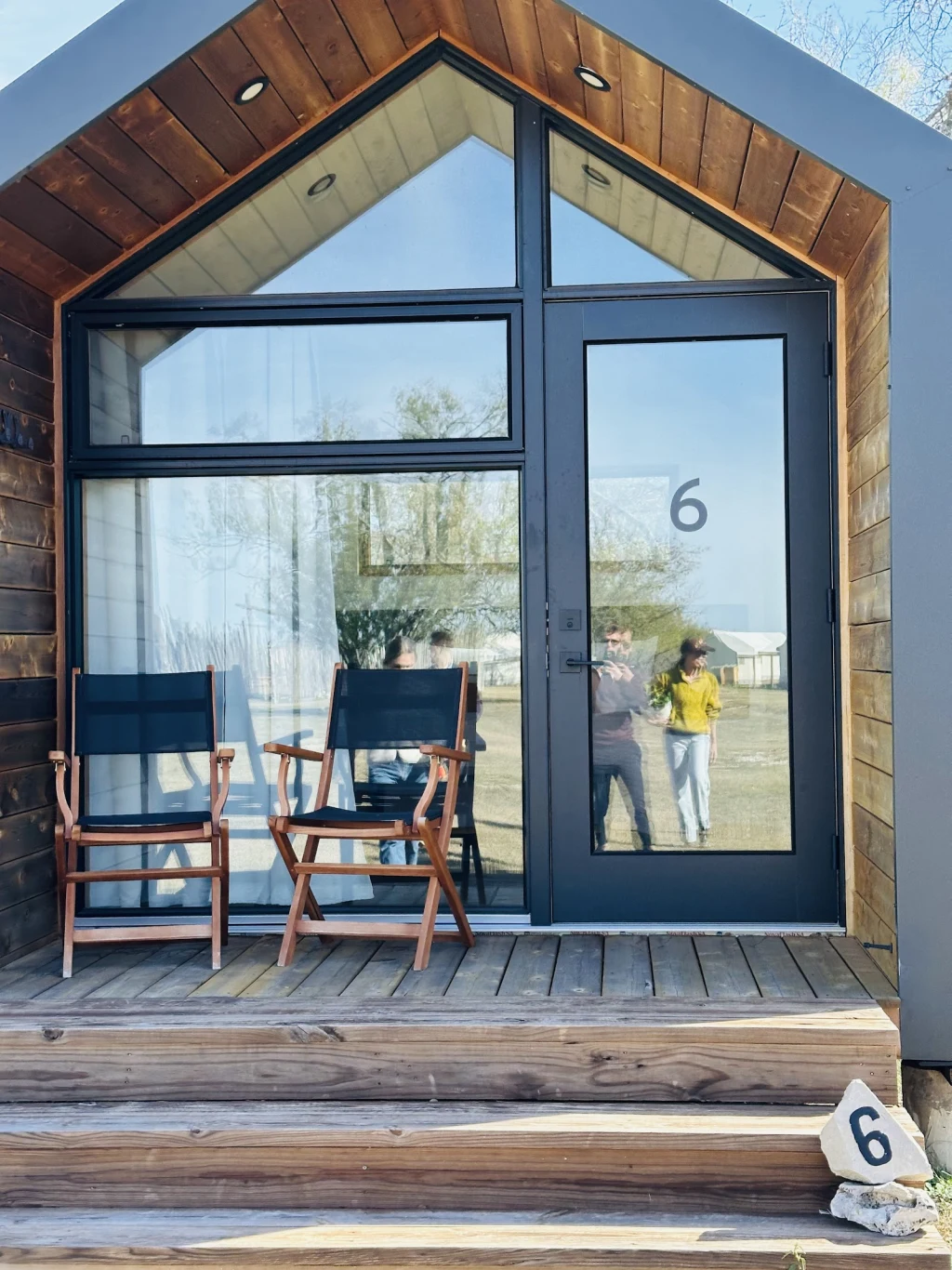 Cabin porch entry with folding chairs at Rancho Moonrise