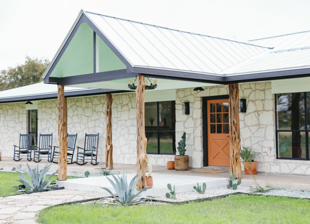 Campfire ring at twilight surrounded by safari tents