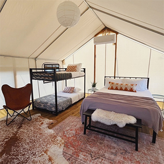 Family safari tent with bunk beds at Rancho Moonrise glamping resort near Austin Texas