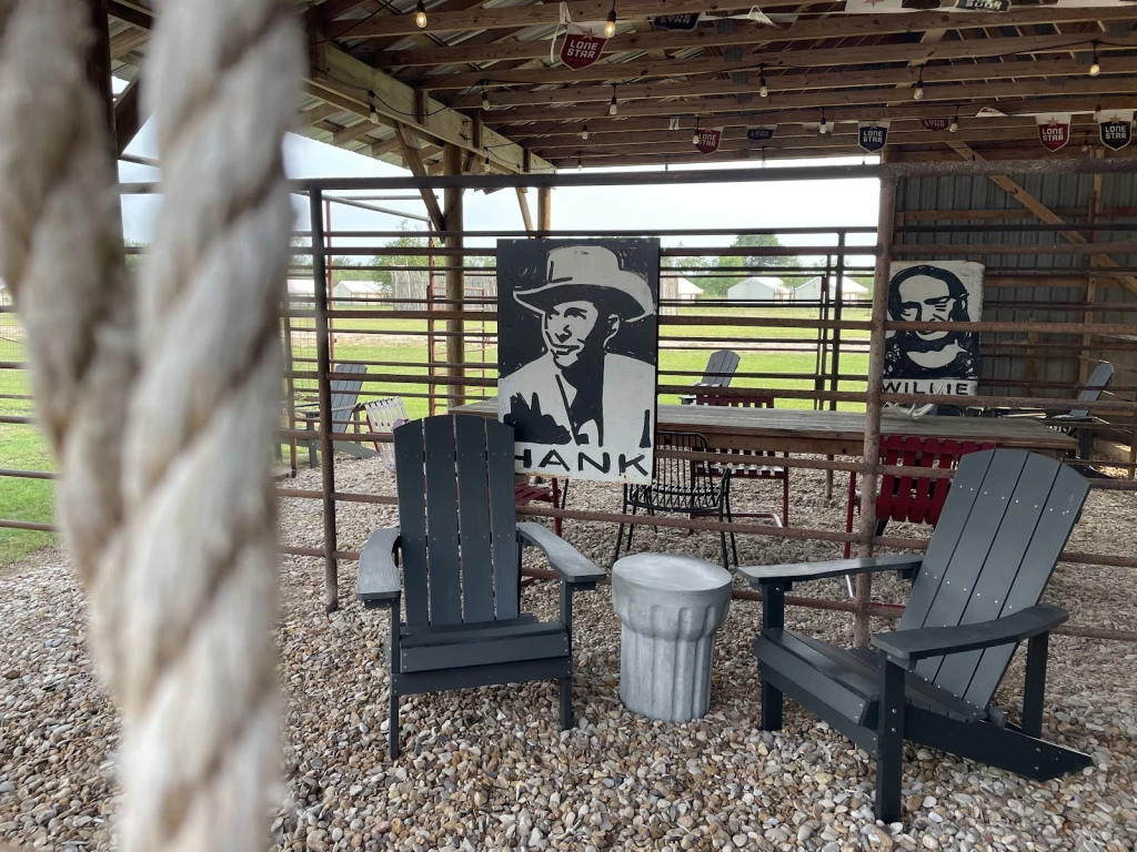 Corral with Adirondack chairs and Hank and Willie portraits at Rancho Moonrise