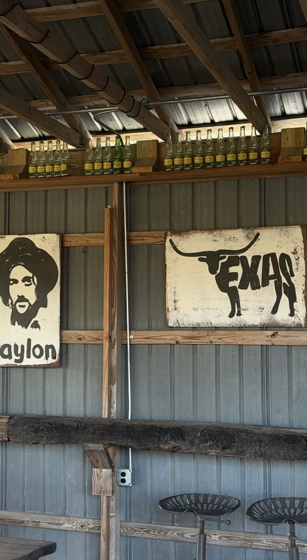 Waylon and Texas signs hanging in the corral outpost at Rancho Moonrise