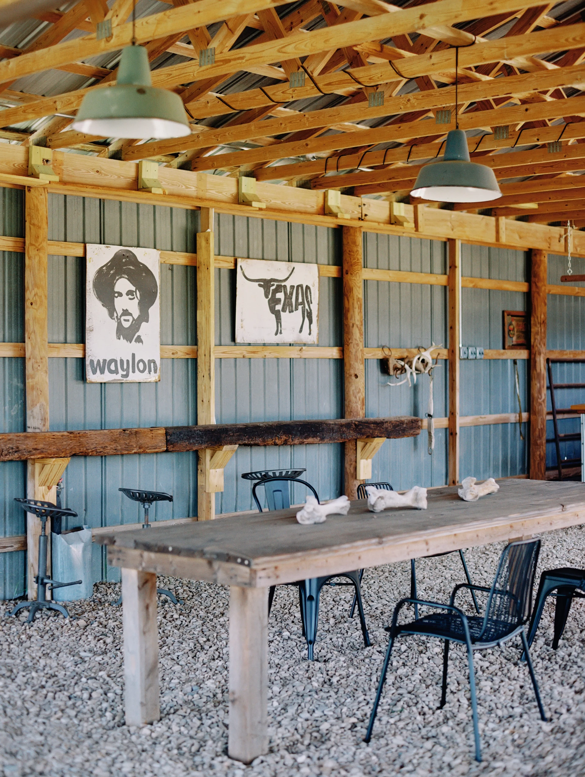 Guests around a campfire at night at Rancho Moonrise with safari tents and starry sky in background
