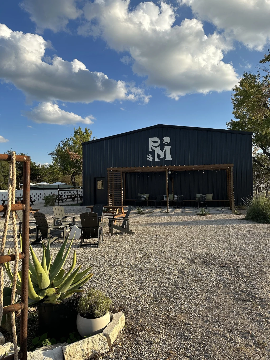 Event Barn with pergola seating and the PM logo at Rancho Moonrise