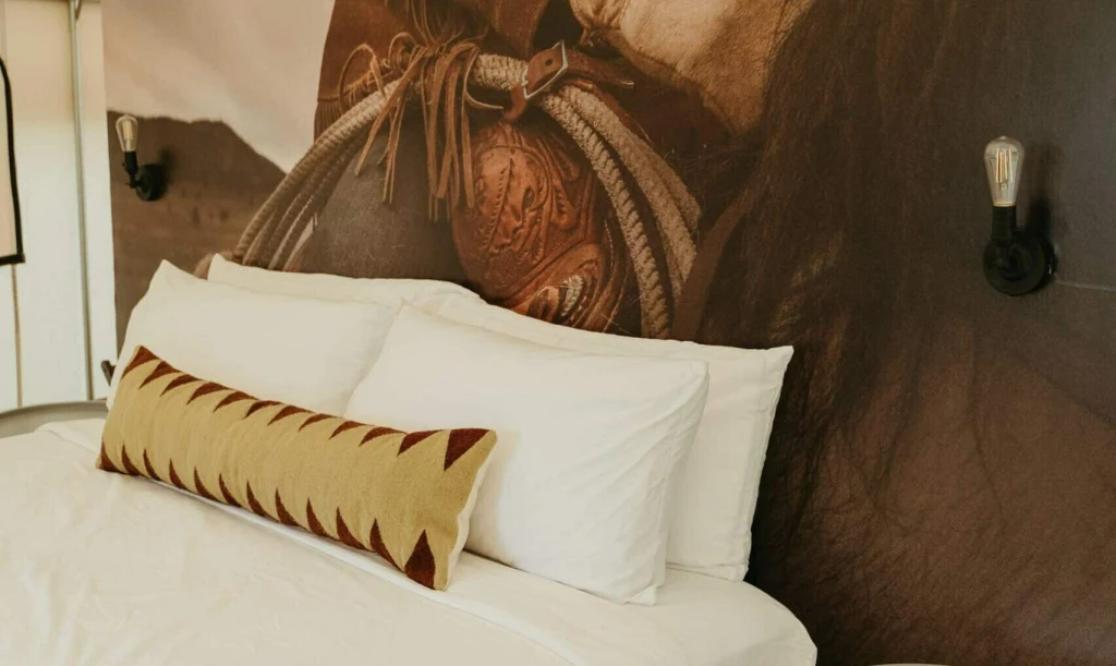 Safari tent interior at Rancho Moonrise with queen bed and string lights