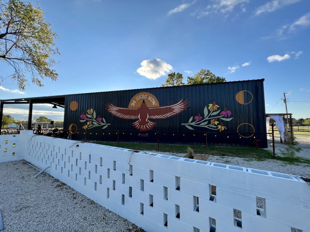 Wide view of the thunderbird mural on the Event Barn exterior