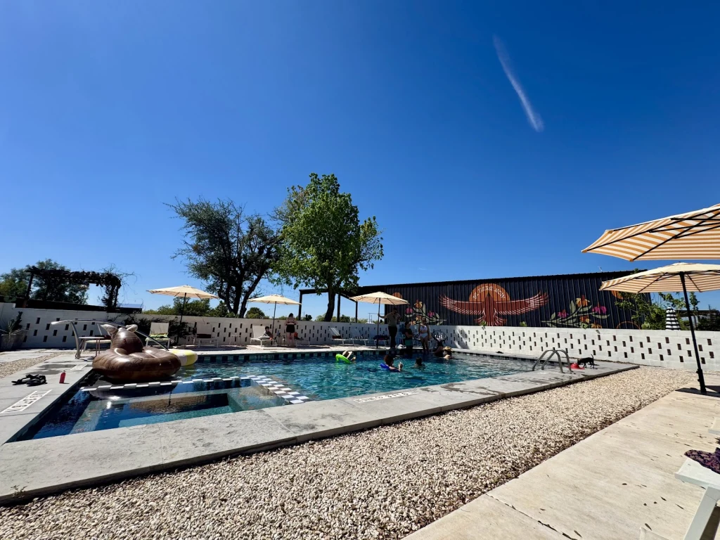 Pool with rubber duck float and the thunderbird mural in the background