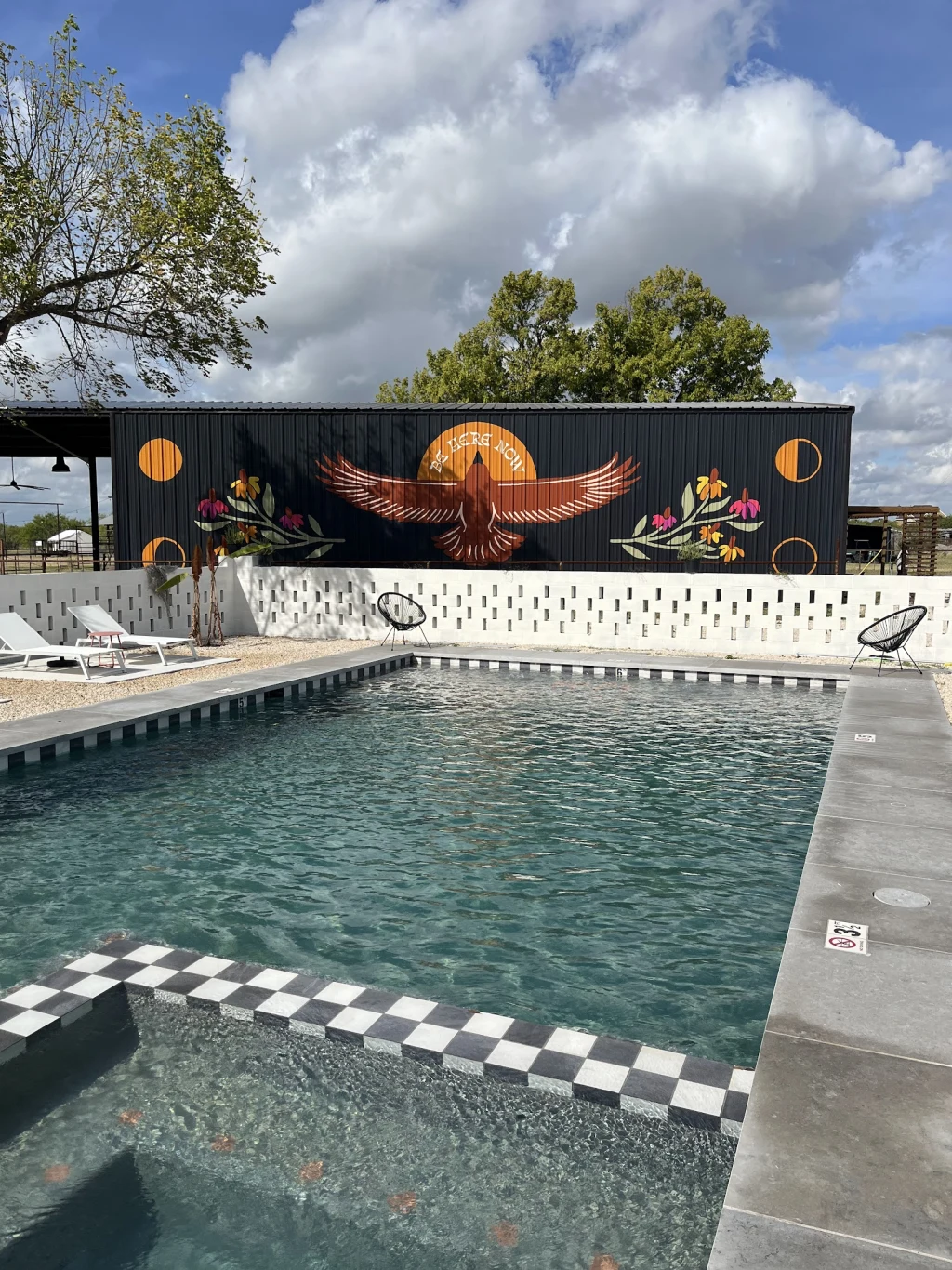 Resort-style pool at Rancho Moonrise with thunderbird mural in the background