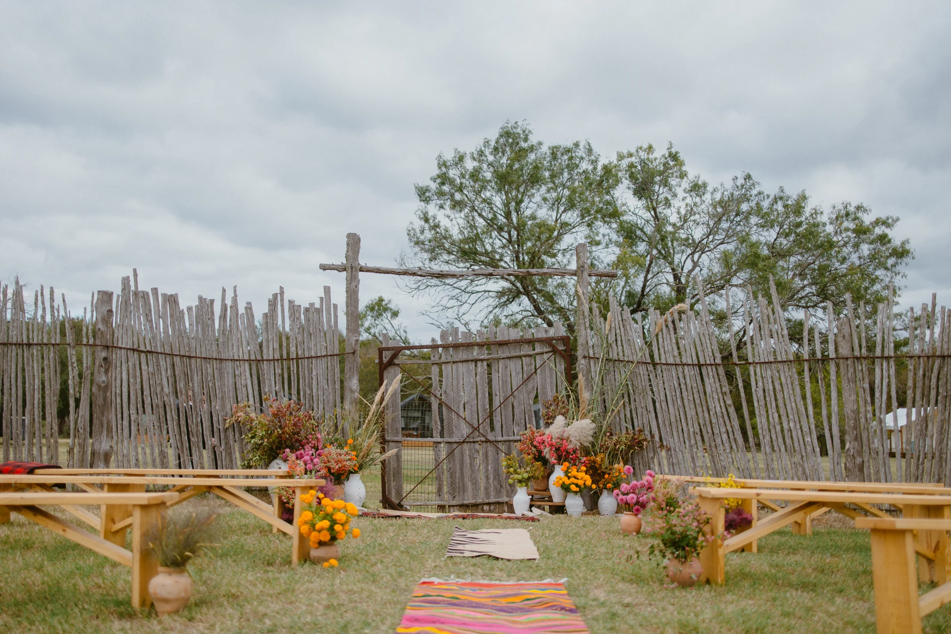 Wedding ceremony in the rustic circular horse corral surrounded by wildflowers at Rancho Moonrise