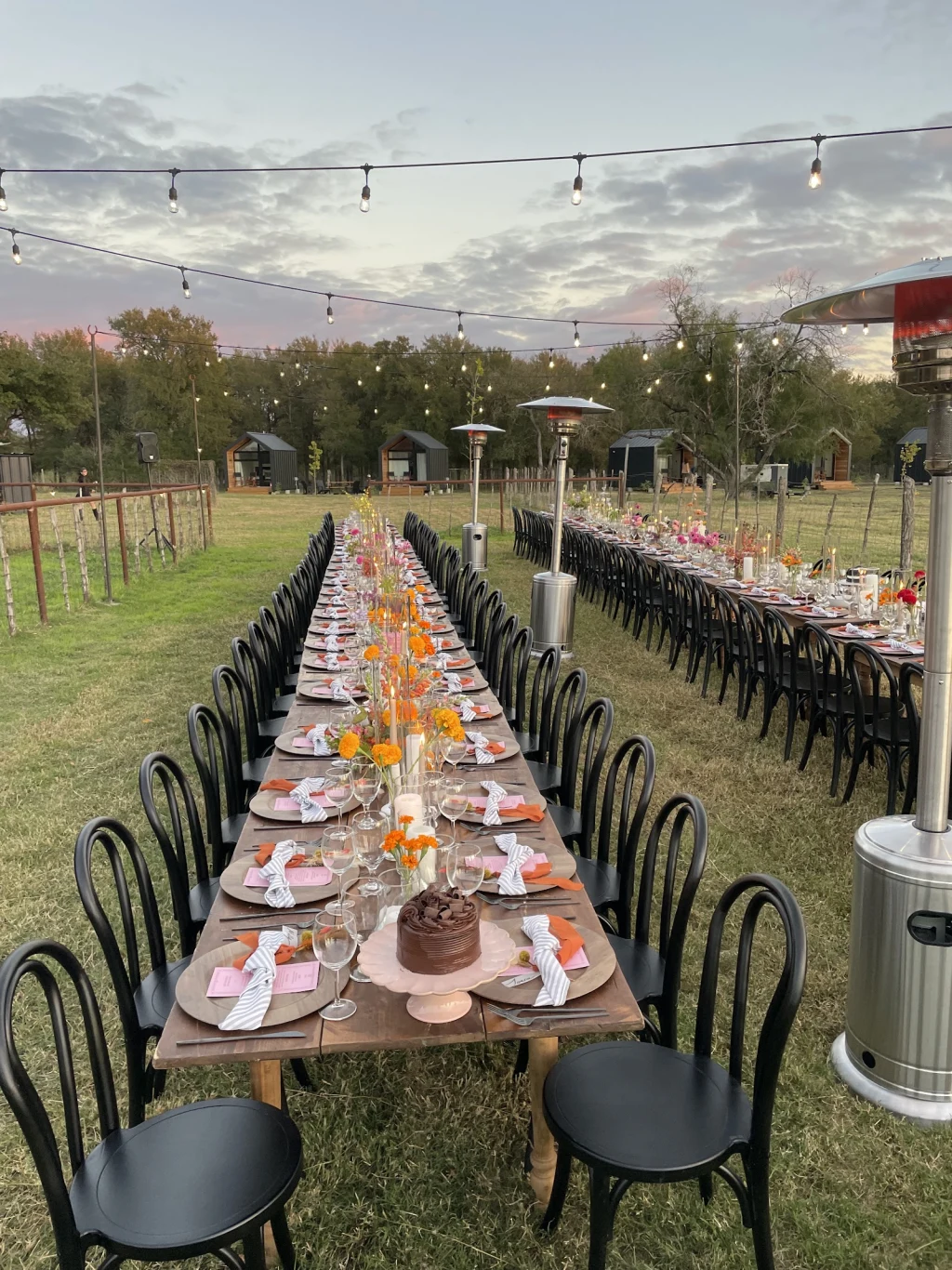 Long reception table at dusk with string lights at Rancho Moonrise