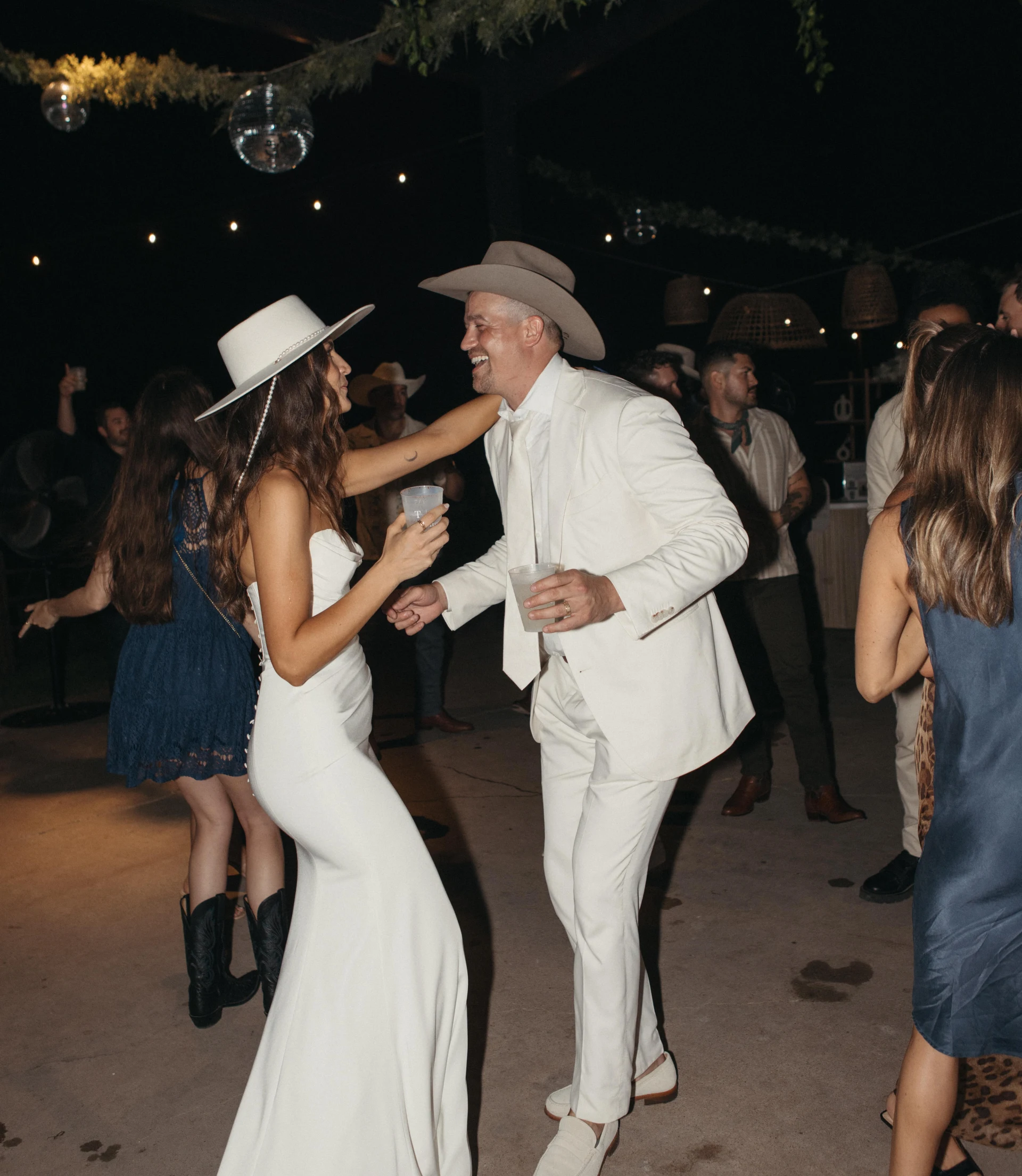 Poolside wedding ceremony at sunset with lounge chairs and tropical landscaping at Rancho Moonrise